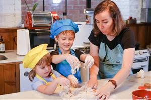 Mom and kids kneading bread