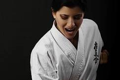Woman in karate gi preparing punch